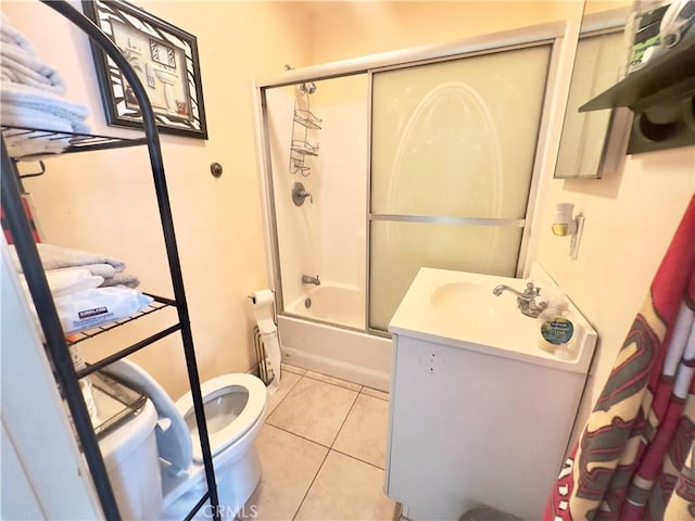 full bathroom featuring tile patterned flooring, vanity, shower / bath combination with glass door, and toilet