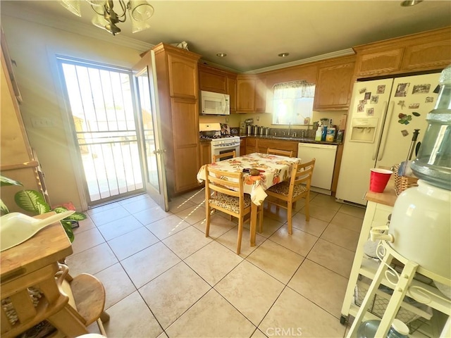 kitchen with crown molding, white appliances, a healthy amount of sunlight, and light tile patterned flooring