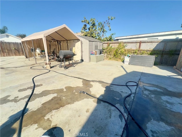 view of patio featuring a storage shed, a gazebo, and grilling area