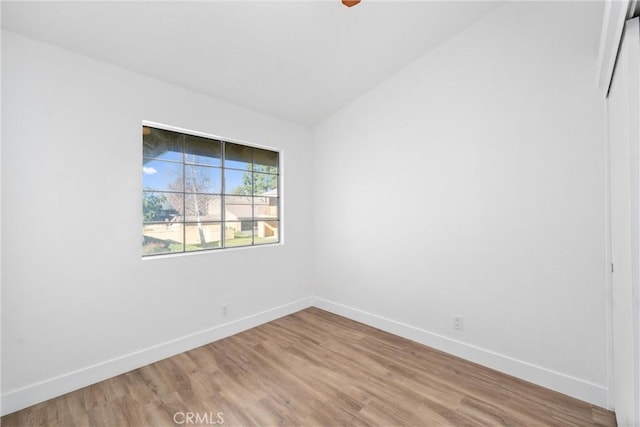 spare room with lofted ceiling and hardwood / wood-style floors