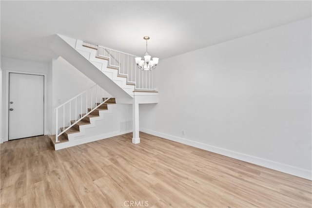 interior space with an inviting chandelier and light hardwood / wood-style flooring