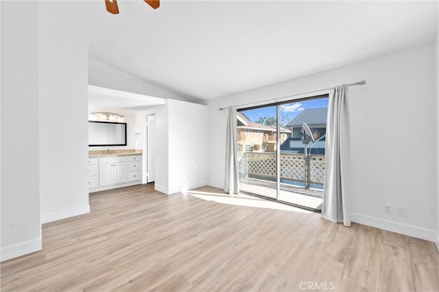 unfurnished living room featuring lofted ceiling, light hardwood / wood-style flooring, and ceiling fan