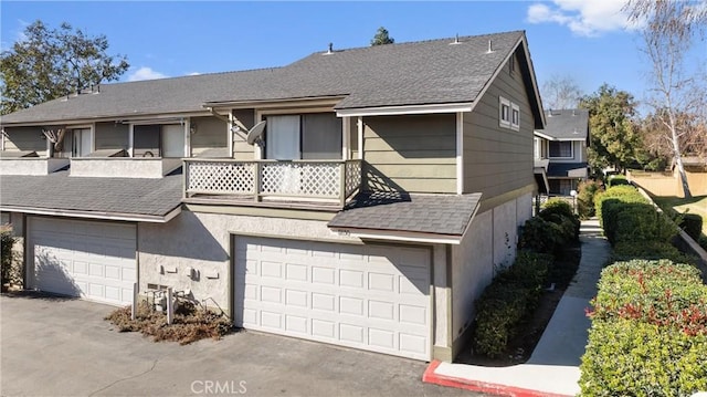 view of front facade featuring a balcony and a garage