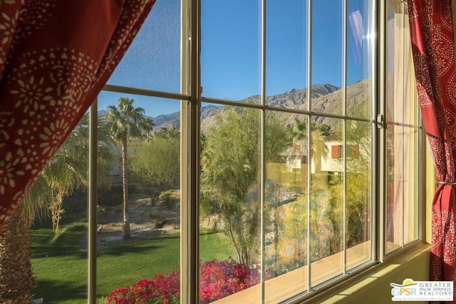 unfurnished sunroom with a mountain view