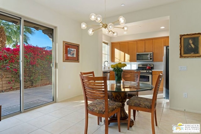 dining room with sink, a notable chandelier, and light tile patterned flooring