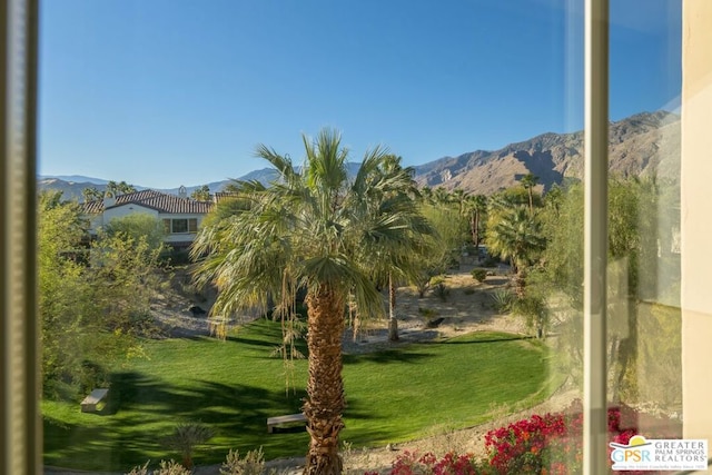 view of home's community featuring a mountain view and a yard