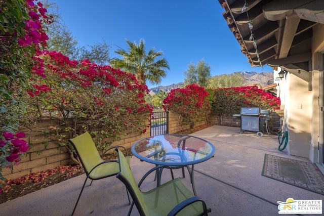 view of patio with a mountain view and grilling area