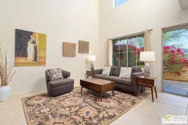 living room featuring a high ceiling, light tile patterned flooring, and a wealth of natural light