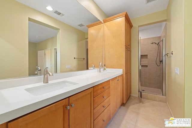 bathroom featuring vanity, a shower with door, and tile patterned floors