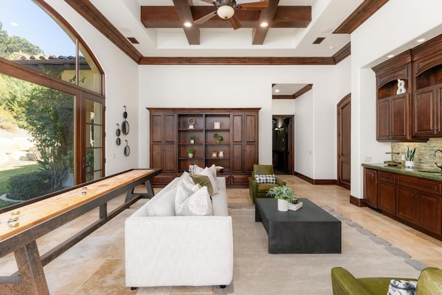 living room featuring a high ceiling, coffered ceiling, sink, and beam ceiling