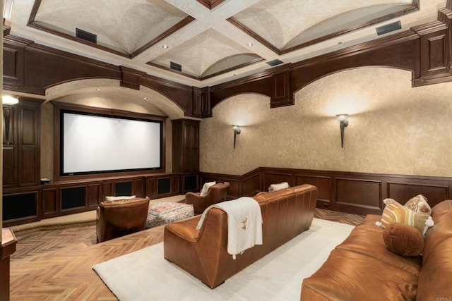 cinema room featuring ornamental molding, coffered ceiling, beam ceiling, and light parquet floors