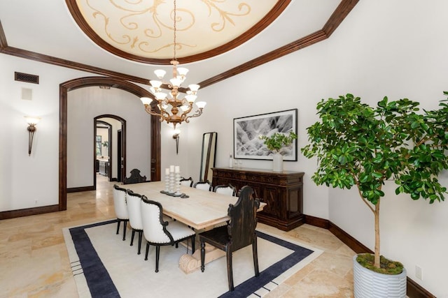 dining room featuring crown molding, a chandelier, and a tray ceiling