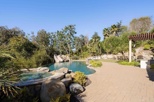 view of pool with an in ground hot tub and a patio area