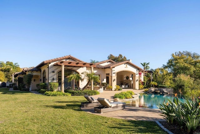 rear view of house with a yard, a pergola, and a patio area