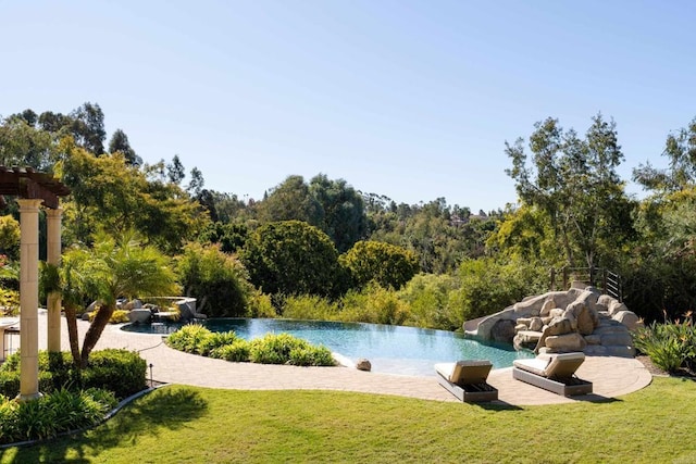 view of swimming pool featuring a yard and a patio