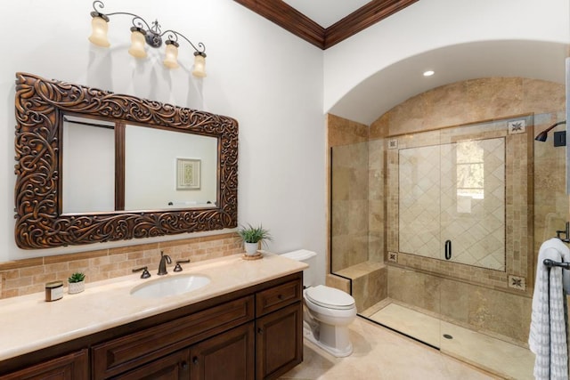 bathroom featuring vanity, ornamental molding, decorative backsplash, toilet, and walk in shower