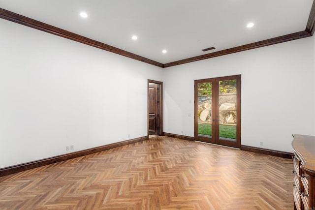 spare room featuring ornamental molding, french doors, and light parquet flooring