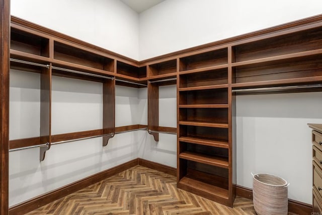 walk in closet with parquet floors