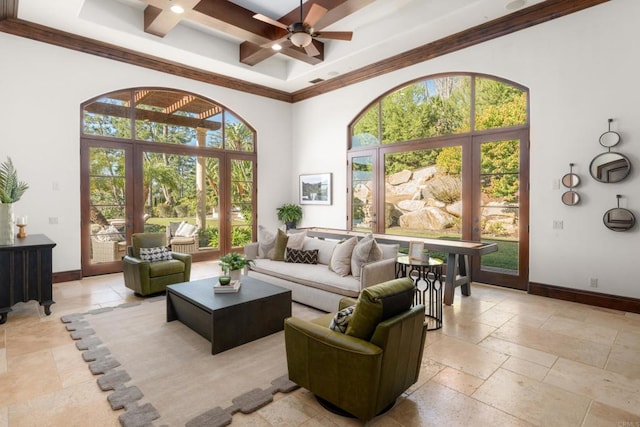 living room featuring crown molding, ceiling fan, beam ceiling, a high ceiling, and coffered ceiling