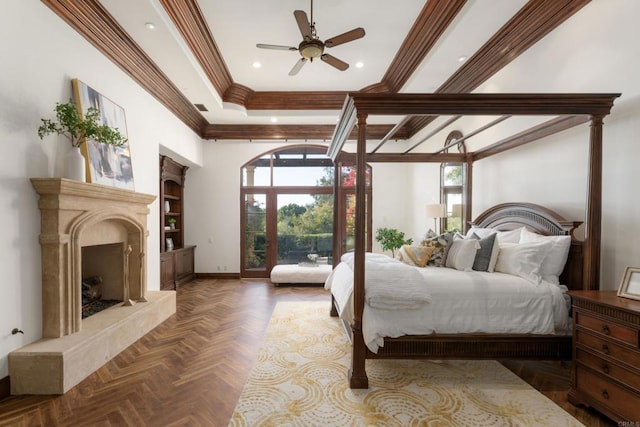 bedroom featuring parquet floors, ceiling fan, a premium fireplace, and multiple windows