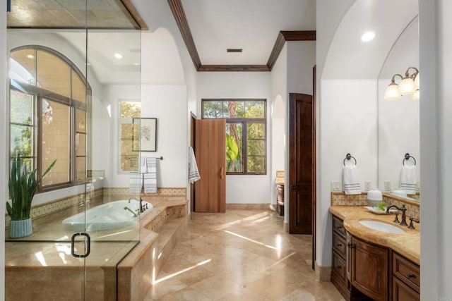 bathroom with crown molding, vanity, and plus walk in shower