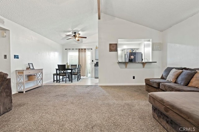 living room with vaulted ceiling, carpet, ceiling fan, and a textured ceiling