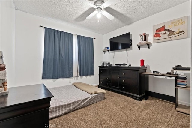 carpeted bedroom featuring a textured ceiling and ceiling fan