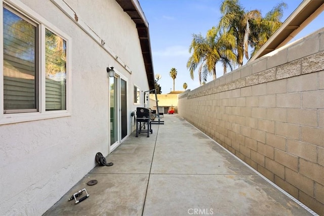 view of property exterior with a patio area