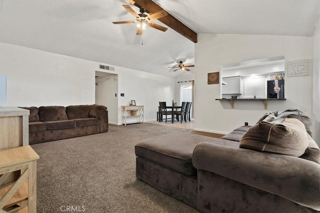 carpeted living room with vaulted ceiling with beams and ceiling fan