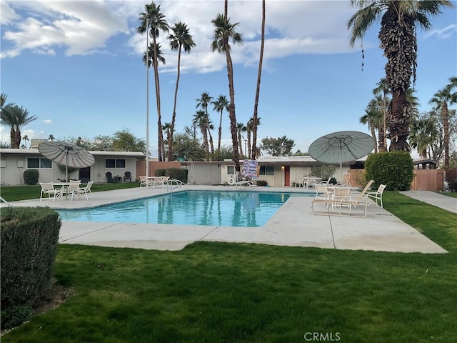 view of swimming pool with a patio and a lawn