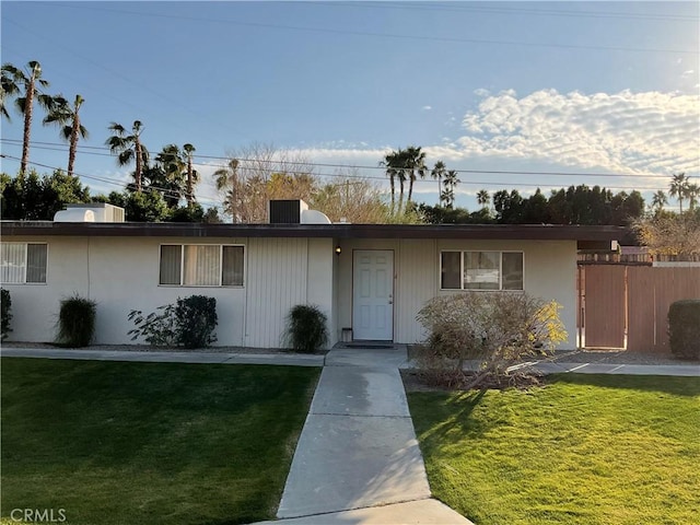 ranch-style house with a front lawn