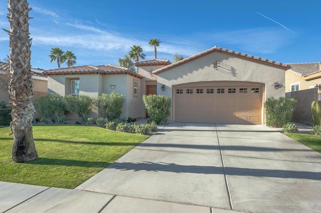 mediterranean / spanish-style house with a garage and a front yard