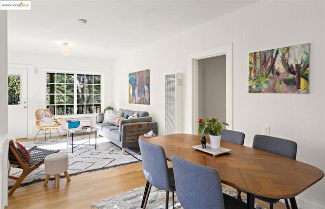 dining space with wood-type flooring