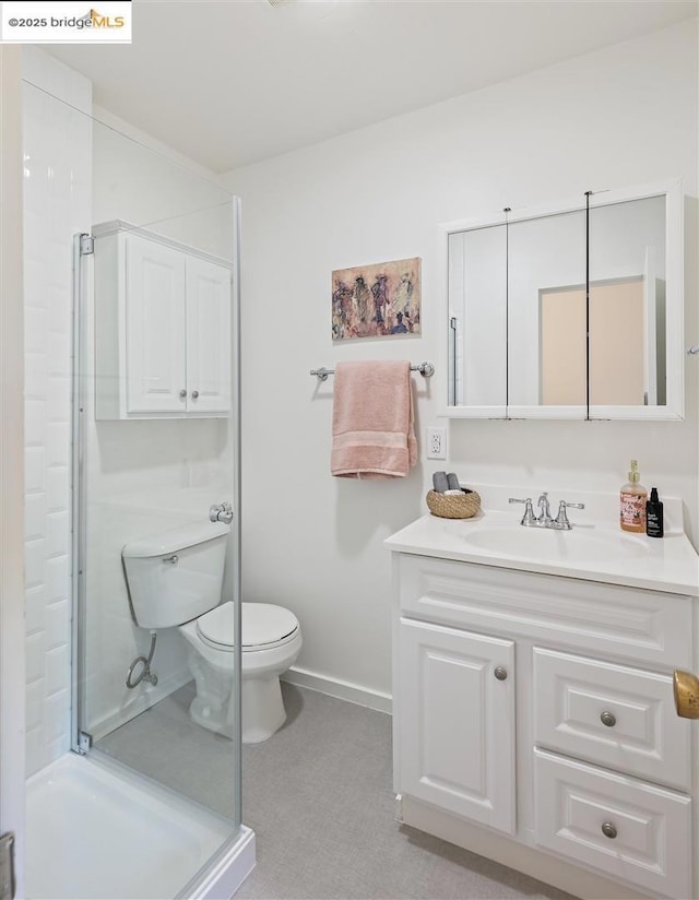 bathroom with vanity, walk in shower, and toilet