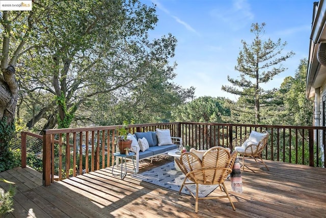 wooden terrace with an outdoor hangout area