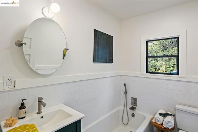 bathroom with vanity, toilet, and a bathing tub