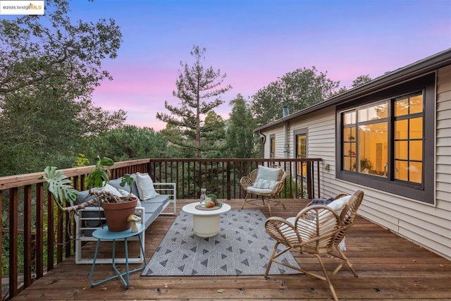 deck at dusk with an outdoor living space