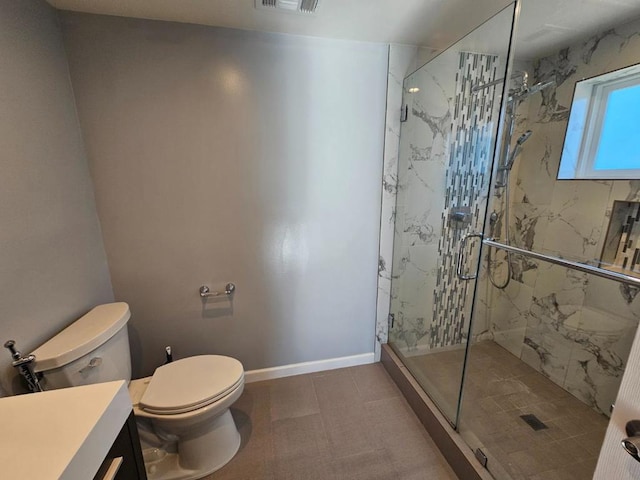 bathroom with an enclosed shower, vanity, and toilet