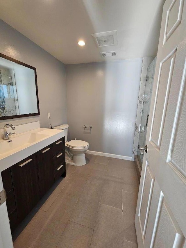 bathroom featuring vanity, toilet, and an enclosed shower