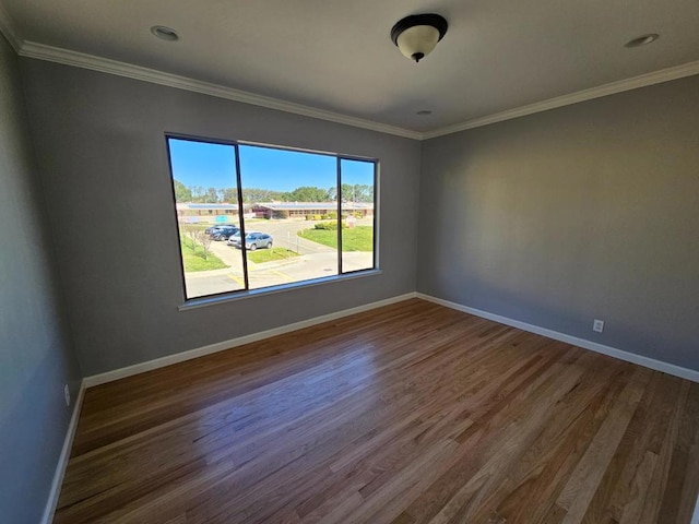 empty room featuring crown molding and dark hardwood / wood-style floors