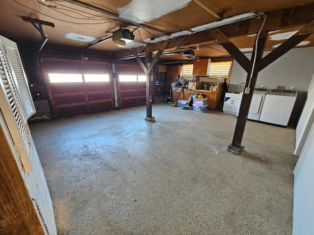 garage with a garage door opener and independent washer and dryer