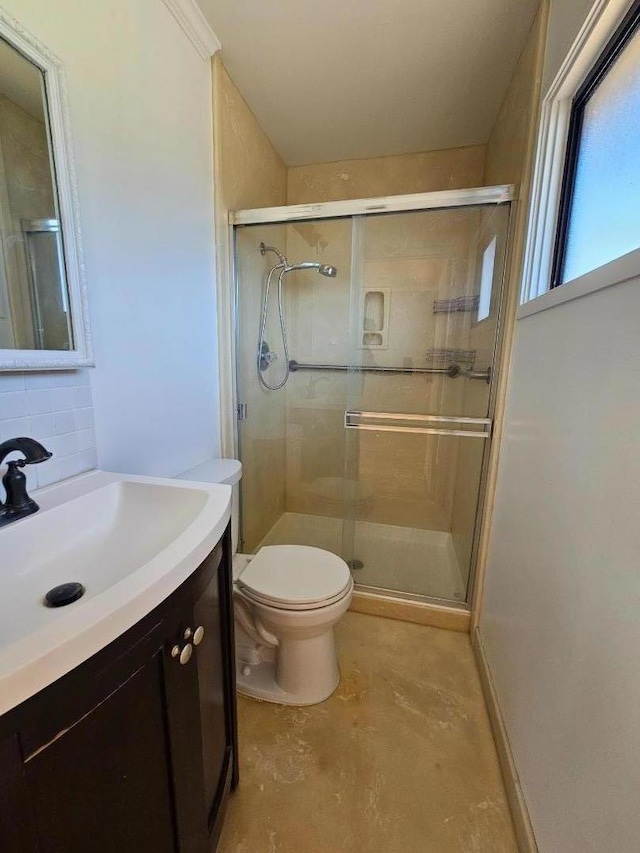 bathroom featuring a shower with door, vanity, decorative backsplash, and toilet