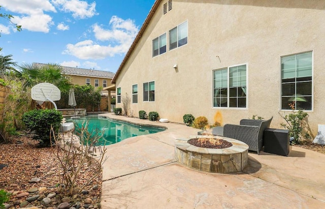 view of pool with a fire pit and a patio