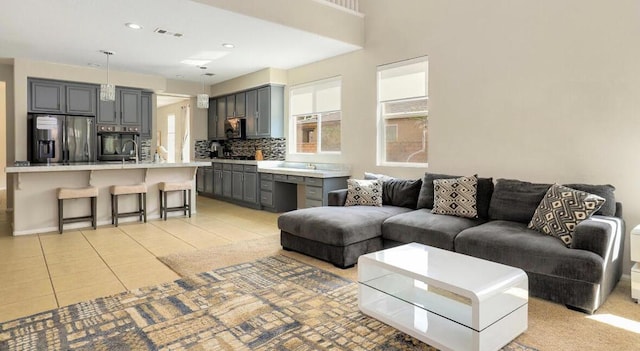 tiled living room featuring sink