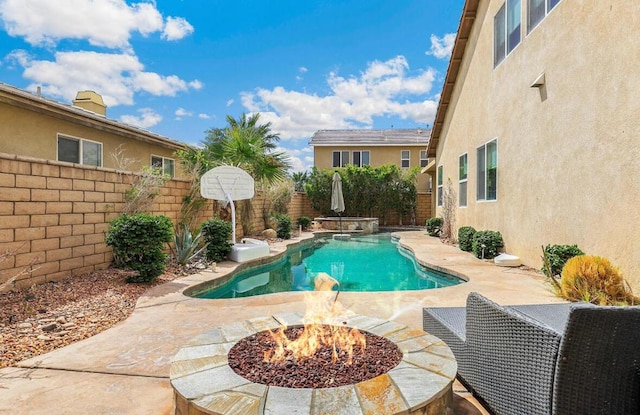 view of swimming pool featuring a patio area and an outdoor fire pit