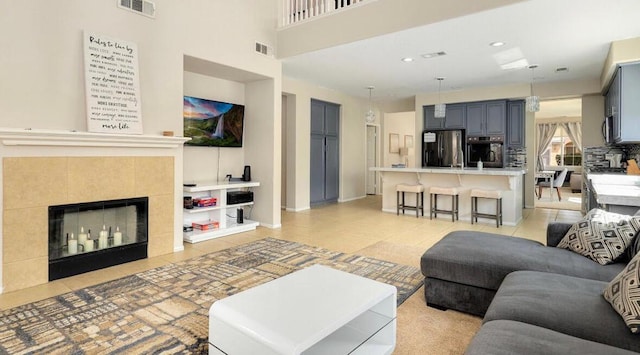 tiled living room with a tile fireplace