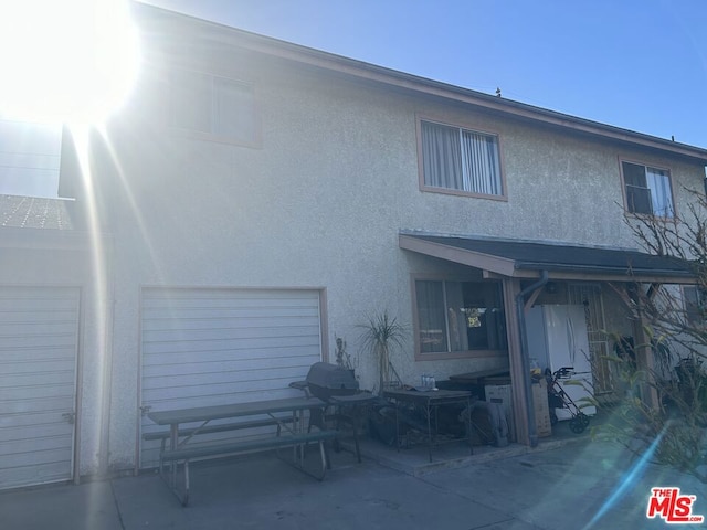 rear view of property with a garage