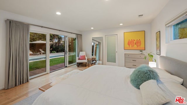 bedroom featuring access to exterior and light wood-type flooring