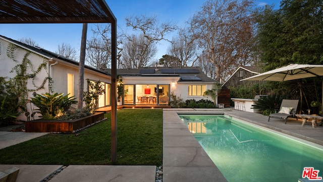 view of swimming pool with a yard and a patio