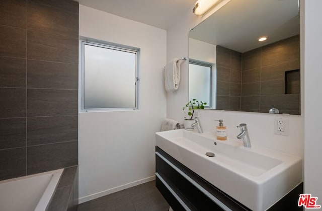 bathroom featuring vanity and a washtub